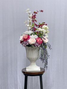 White urn vase with pastel flowers